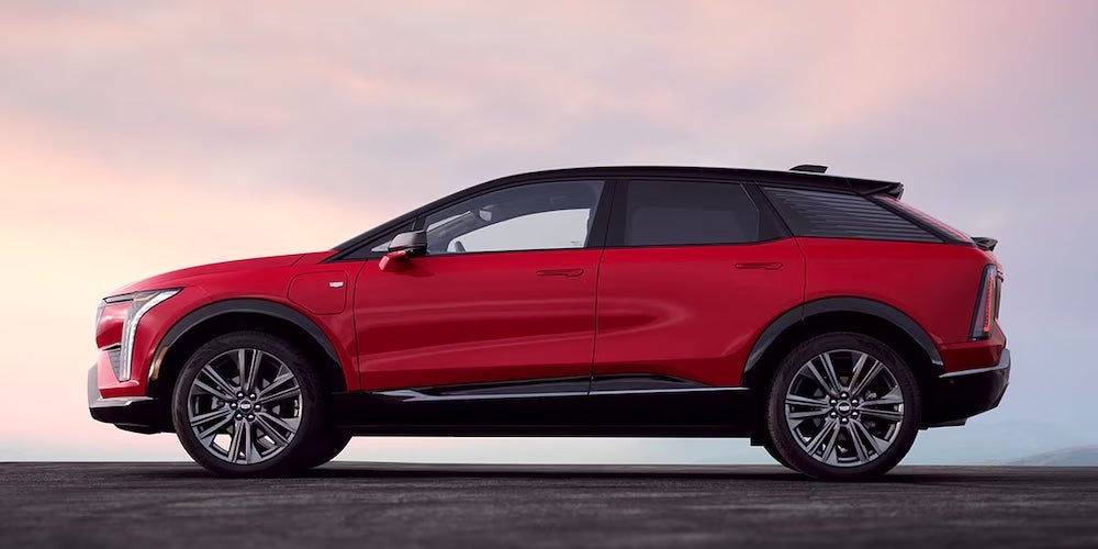 A side view of a red 2026 Cadillac Optiq electric SUV